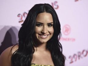 FILE - In this Dec. 6, 2017 file photo, Demi Lovato arrives at the West Coast debut of 29rooms at ROW DTLA in Los Angeles. Lovato has checked out of the hospital she was rushed to two weeks ago for a reported overdose. A person close to Lovato says she was released from Cedars-Sinai hospital in Los Angeles over the weekend.  Lovato was hospitalized on July 24.