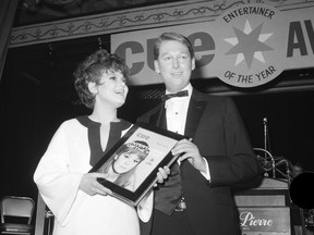 FILE - In this Jan. 4, 1967 file photo, Barbara Harris, star of "The Apple Tree" receives Cue Magazine's "Entertainer of the Year" award from last year's winner, director Mike Nichols in New York. Harris, the Tony-winning actress whose intelligence, impish good looks and winsomely neurotic manner brightened Broadway musicals in the '60s and films such as "Nashville," "Freaky Friday" and "A Thousand Clowns" has died. She was 83.