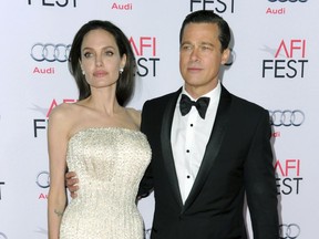 FILE - In this Nov. 5, 2015 file photo, Angelina Jolie, left, and Brad Pitt arrive at the 2015 AFI Fest opening night premiere of "By The Sea" in Los Angeles. Jolie Pitt says she wants her divorce from Brad Pitt finalized before the end of the year, and that she intends to seek retroactive child support. The declarations came in a request for a case-management conference filed Tuesday by Jolie Pitt's attorneys in Los Angeles Superior Court.