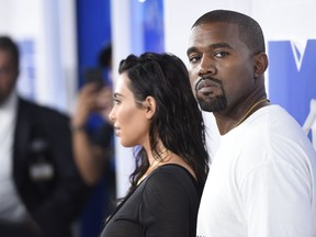 FILE - In this Aug. 28, 2016 file photo, Kim Kardashian West, left, and Kanye West arrive at the MTV Video Music Awards in New York. Kanye West has apologized on a Chicago radio station for suggesting slavery was a "choice."