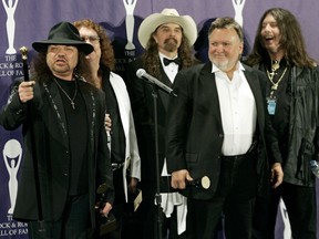 FILE - In this March 13, 2006 file photo, members of Lynyrd Skynyrd, from left, Gary Rossington, Billy Powell, Artimus Pyle, Ed King and Bob Burns, appear backstage after being inducted at the annual Rock and Roll Hall of Fame dinner in New York.  A family statement said King, who helped write several of their hits including "Sweet Home Alabama," died from cancer, Wednesday, Aug. 22, 2018, in Nashville, Tenn. He was 68.