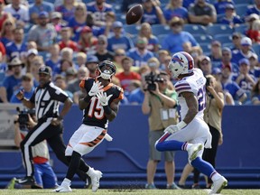 Cincinnati Bengals wide receiver John Ross (15) catches a pass in front of Buffalo Bills' Jordan Poyer (21) during the first half of a preseason NFL football game Sunday, Aug. 26, 2018, in Orchard Park, N.Y. Ross scored a touchdown on the play.