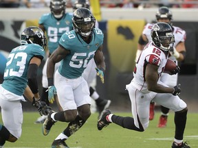 In this Aug. 25, 2018, photo, Atlanta Falcons wide receiver Mohamed Sanu (12) runs after catching a pass in front of Jacksonville Jaguars defensive back Tyler Patmon (23) and linebacker Telvin Smith (50) during the first half of an NFL preseason football game in Jacksonville, Fla. The Jaguars relied on stout defense to win the AFC South and reach the conference title game last season. They return 12 of their top 14 players on that side of the ball and believe they will be even better this fall.