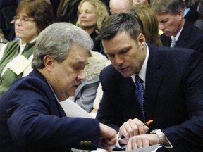 FILE - In this Jan. 31, 2011, file photo, Kansas Secretary of State Kris Kobach, right, confers with Assistant Secretary of State Eric Rucker during a Kansas House Elections Committee hearing on Kobach's bill for cracking down on election fraud at the Statehouse in Topeka, Kan. Kobach says he's stepping aside from his duties as the state's top elections official while his hotly contested Republican primary race with Gov. Jeff Colyer remains unresolved. Kobach announced his decision Friday, Aug. 10, 2018, in a letter to Colyer. Kobach said he is handing his election duties over to Rucker.