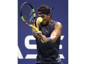 Rafael Nadal, of Spain, returns a shot to David Ferrer, also of Spain, during the first round of the U.S. Open tennis tournament, Monday, Aug. 27, 2018, in New York.
