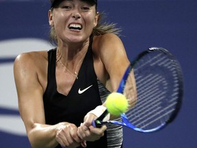 Maria Sharapova, of Russia, returns a shot to Patty Schnyder, of Switzerland, during the first round of the U.S. Open tennis tournament, Tuesday, Aug. 28, 2018, in New York.