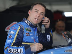 Kevin Harvick adjusts his ear plugs before a practice session for a NASCAR Cup series auto race, Saturday, Aug. 4, 2018, in Watkins Glen, N.Y.