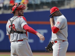 Cincinnati Reds relief pitcher Keury Mella, right, wipes sweat from his face as catcher Curt Casali (38) approaches the mound during the eighth inning of a baseball game against the New York Mets, Wednesday, Aug. 8, 2018, in New York. The Mets won 8-0.