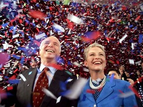 FILE - In this Jan. 30, 2000, file photo, confetti falls on Republican presidential hopeful Sen. John McCain, R-Ariz., and his wife, Cindy, at the end of their 114th New Hampshire town hall meeting with voters at the Peterborough Town House in Peterborough, N.H. Aide says senator, war hero and GOP presidential candidate McCain died Saturday, Aug. 25, 2018. He was 81.