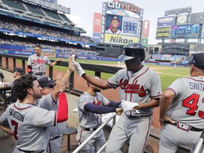 Atlanta Braves' Julio Teheran, center, celebrates with teammates after hitting a home run during the fifth inning of a baseball game against the New York Mets Sunday, Aug. 5, 2018, in New York.