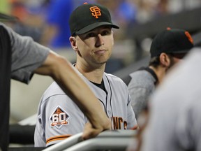 San Francisco Giants' Buster Posey watches his team play during the sixth inning of a baseball game against the New York Mets Tuesday, Aug. 21, 2018, in New York.