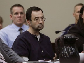 FILE - In this Jan. 24, 2018 file photo, Larry Nassar sits during his sentencing hearing in Lansing, Mich. Michigan State can't win enough football games this season to change the ugliness of the school's recent past. The Larry Nassar sex abuse scandal and lingering questions about the school's football and basketball programs have put the university under a bad spotlight. This year's football team is hoping that players have learned the right lessons. The players remind each other to make good choices and avoid stupid behavior.