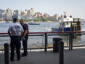 Authorities investigate the death of a baby boy who was found floating in the water near the Brooklyn Bridge in Manhattan, on Sunday, Aug. 5, 2018, in New York. No parent or guardian was present at the scene and the child showed no signs of trauma, police said. The medical examiner will determine the exact cause of death.