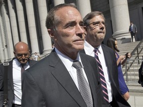 FILE - This Aug. 8, 2018 file photo shows Republican U.S. Rep. Christopher Collins as he leaves federal court in New York. In an about-face, Collins says he will suspend his re-election campaign after insider-trading indictment.