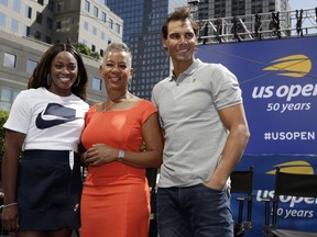 Defending champions Sloane Stephens, left, and Rafael Nadal flank USTA President and CEO Katrina Adams during the reveal of the 2018 U.S. Open draw in New York, Thursday, Aug. 23, 2018. Serena and Venus Williams could be headed toward their earliest Grand Slam meeting in 20 years, facing a potential third-round matchup at the U.S. Open.