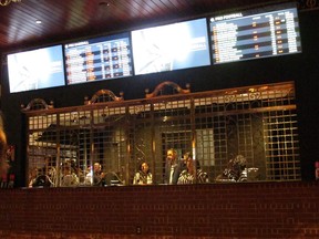 FILE - This Monday, July 30, 2018, file photo, shows the sports betting section of Bally's casino in Atlantic City, N.J. Harrah's casino plans to start taking sports bets at 11 a.m. Wednesday, Aug. 1, 2018, two days after its sister property, Bally's, did.