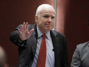 FILE - In this June 3, 2016, file photo, Sen. John McCain, R-Ariz., greets the audience as he arrives to deliver a speech in Singapore. McCain, the war hero who became the GOP's standard-bearer in the 2008 election, died Saturday, Aug. 25, 2018. He was 81.