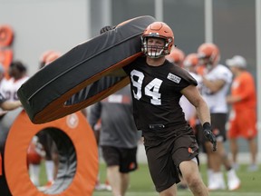 FILE - In this Thursday, July 26, 2018, file photo, Cleveland Browns defensive end Carl Nassib runs a drill during NFL football training camp, in Berea, Ohio. Browns defensive end Nassib needs to work on more than his pass rushing skills in training camp. His grandma wants him to clean up his language.