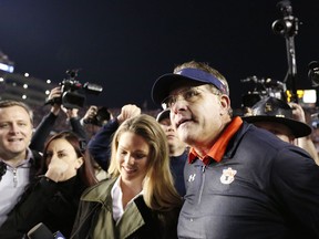 FILE-In this Nov. 25, 2017, file photo, Auburn head coach Gus Malzahn on the field talks to the media after the Iron Bowl NCAA college football game in Auburn, Ala. The team will have to navigate what Malzahn has been calling "the toughest schedule in college football." "It's a man's league, and if you win the West, you really do something," Malzahn, who has a new seven-year contract, said.