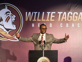FILE - In this Dec. 6, 2017, file photo, Willie Taggart gestures as he is introduced as Florida State's new football coach during an NCAA college football news conference in Tallahassee, Fla.  Taggart's first eight months as Florida State's coach could not have gone much better. He has reinvigorated a team and fan base that has found itself out of contention for a College Football Playoff spot by early October the past two seasons and saw Jimbo Fisher leave for Texas A&M last December. As Florida State prepares for Taggart's first season the biggest question is how long will Taggart's honeymoon last.