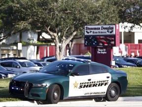 FILE - In an Aug. 15, 2018 file photo, a Broward County Sheriff's Office vehicle is parked outside Marjory Stoneman Douglas High School, in Parkland, Fla. Florida's top incoming legislative leaders are rejecting Gov. Rick Scott's push to redirect $58 million so school districts can hire more campus police officers. House Speaker-elect Jose Oliva and incoming Senate President-elect Bill Galvano, both Republicans, said Wednesday, Aug, 22, 2018 that the money should remain budgeted for the state's guardian program.