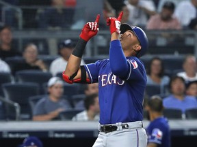 Texas Rangers' Ronald Guzman reacts as he crosses the plate after hitting a solo home run against the New York Yankees during the fourth inning of a baseball game Friday, Aug. 10, 2018, in New York.