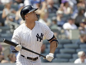 New York Yankees' Giancarlo Stanton watches his solo home run off Toronto Blue Jays starting pitcher Sean Reid-Foley during the fourth inning of a baseball game, Saturday, Aug. 18, 2018, in New York.