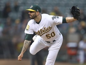 Oakland Athletics pitcher Mike Fiers works against the Texas Rangers in the first inning of a baseball game Monday, Aug. 20, 2018, in Oakland, Calif.