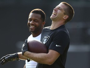 Oakland Raiders wide receiver Jordy Nelson, right, laughs with Green Bay Packers wide receiver Randall Cobb before an NFL preseason football game between the Raiders and the Packers in Oakland, Calif., Friday, Aug. 24, 2018.