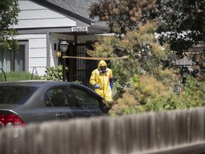 An Aurora, Colo., Police Department officer in a protective suit exits the home of a man who was shot and killed by an officer Tuesday, July 31, 2018, in Aurora, Colo.