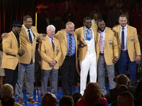 The 2018 Class of the Pro Football Hall of Fame poses during the Pro Football Hall of Fame Enshrinement Festival Enshrinee's Gold Jacket Dinner on Friday, Aug. 3, 2018, in Canton, Ohio. From left are Brian Dawkins, Robert Brazile, Bobby Beathard, Jerry Kramer, Randy Moss, Ray Lewis, and Brian Urlacher.