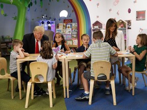 President Donald Trump and first lady Melania Trump talk with a group of children during a visit the Nationwide Children's Hospital, Friday, Aug. 24, 2018, in Columbus, Ohio.