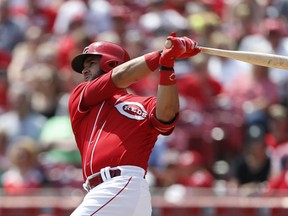 Cincinnati Reds' Eugenio Suarez follows through on a two-run home run off San Francisco Giants starting pitcher Andrew Suarez during the third inning of a baseball game, Sunday, Aug. 19, 2018, in Cincinnati.