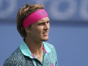 Alexander Zverev, of Germany, reacts during a match against Robin Haase, of the Netherlands, in the second round at the Western & Southern Open tennis tournament, Wednesday, Aug. 15, 2018, in Mason, Ohio.