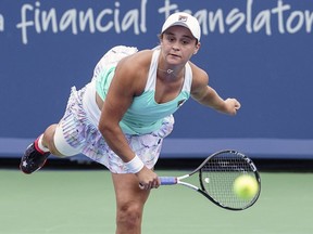 Ashleigh Barty, of Australia, serves to Simona Halep, of Romania, at the Western & Southern Open tennis tournament, Friday, Aug. 17, 2018, in Mason, Ohio.