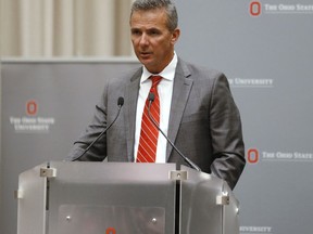 Ohio State football coach Urban Meyer makes a statement during a news conference in Columbus, Ohio, Wednesday, Aug. 22, 2018. Ohio State suspended Meyer on Wednesday for three games for mishandling domestic violence accusations, punishing one of the sport's most prominent leaders for keeping an assistant on staff for several years after the coach's wife accused him of abuse. Athletic director Gene Smith was suspended from Aug. 31 through Sept. 16.