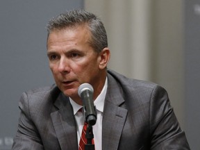 Ohio State football coach Urban Meyer makes a statement during a news conference in Columbus, Ohio, Wednesday, Aug. 22, 2018. Ohio State suspended Meyer on Wednesday for three games for mishandling domestic violence accusations, punishing one of the sport's most prominent leaders for keeping an assistant on staff for several years after the coach's wife accused him of abuse. Athletic director Gene Smith was suspended from Aug. 31 through Sept. 16.