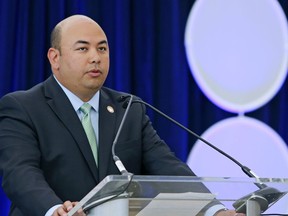FILE – In this June 28, 2016, file photo, Ohio House Speaker Cliff Rosenberger marks the passage of legislation to rename Port Columbus International Airport to John Glenn Columbus International Airport, during an event at the airport in Columbus, Ohio. Federal investigators seized records from Rosenberger's office in 2018 as part of a federal criminal investigation into potential bribes and kickbacks surrounding payday lending legislation, according to a subpoena and search warrant released Monday, Aug. 27, 2018, in response to public records requests. Rosenberger, a Republican rising star, resigned suddenly on April 12.