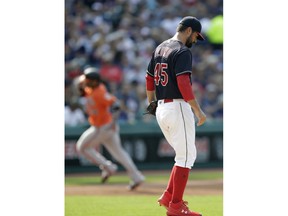 Cleveland Indians starting pitcher Adam Plutko, right, waits for Baltimore Orioles' Jonathan Villar to run the bases after Villar hit a three-run home run in the third inning of a baseball game, Saturday, Aug. 18, 2018, in Cleveland.