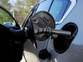 In this April 23, 2018, file photo a car is filled with gasoline at a station in Windham, N.H. Conserving oil is no longer an economic imperative for the U.S., the Trump administration declares in a major new policy statement that threatens to undermine decades of government campaigns for gas-thrifty cars and other conservation programs.