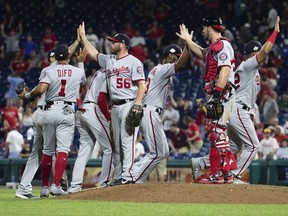 The Washington Nationals celebrate their 5-4 win after the ninth inning of a baseball game against the Philadelphia Phillies, Tuesday, Aug. 28, 2018, in Philadelphia.