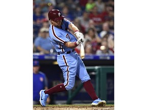 Philadelphia Phillies' Rhys Hoskins hits a three-run home run off New York Mets' Steven Matz during the first inning of the second baseball game in a doubleheader, Thursday, Aug. 16, 2018, in Philadelphia.