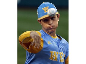 Honolulu's Aukai Kea delivers in the first inning of a baseball game against Staten Island (N.Y.) at the Little League World Series in South Williamsport, Pa., Wednesday, Aug. 22, 2018.