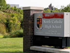 Paint covers the name of Cardinal Wuerl at Cardinal Wuerl North Catholic High School, on Monday, Aug. 20, 2018, in Cranberry Township, Pa. Wuerl, a Roman Catholic Cardinal, and the archbishop of Washington, D.C., has come under fire from revelations in the Pennsylvania grand jury report about his actions while bishop of Pittsburgh.