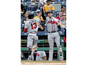 Atlanta Braves' Ronald Acuna Jr. (13) celebrates with Freddie Freeman after hitting a solo home run against the Pittsburgh Pirates during the first inning of a baseball game Wednesday, Aug. 22, 2018, in Pittsburgh.
