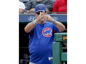Chicago Cubs manager Joe Maddon call for a timeout with the bases loaded to pull the outfield in and have an outfielder change gloves as the Pittsburgh Pirates bat in the ninth inning of a baseball game Sunday, Aug. 19, 2018, in Pittsburgh.