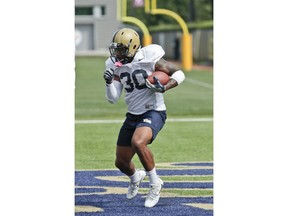 FILE - In this Aug. 10, 2018,  file photo, Pittsburgh running back Qadree Ollison goes through drills during an NCAA college football practice, in Pittsburgh. Senior running backs Ollison and Darrin Hall head into their final seasons with the Panthers looking to put an uneven 2017 behind them. Pitt will need them to be consistently productive to take some of the pressure off quarterback Kenny Pickett.