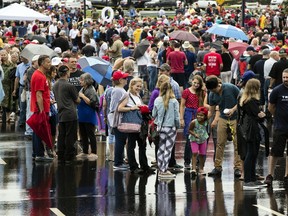 People wait in line to enter a campaign rally with President Donald Trump and U.S. Senate candidate Rep. Lou Barletta, R-Pa., Thursday, Aug. 2, 2018, in Wilkes-Barre, Pa.