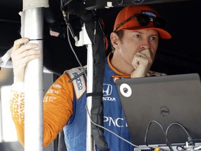 Scott Dixon waits in his pit box before a practice session for Sunday's IndyCar series auto race, Saturday, Aug. 18, 2018, in Long Pond, Pa.