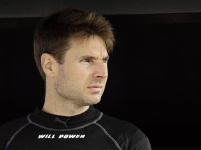 Will Power looks out from his pit box before a practice session for Sunday's IndyCar series auto race, Saturday, Aug. 18, 2018, in Long Pond, Pa.